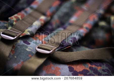 Military Camouflage Roomy Backpack. In The Frame Of The Strap And The Back Of A Backpack. Close-up V