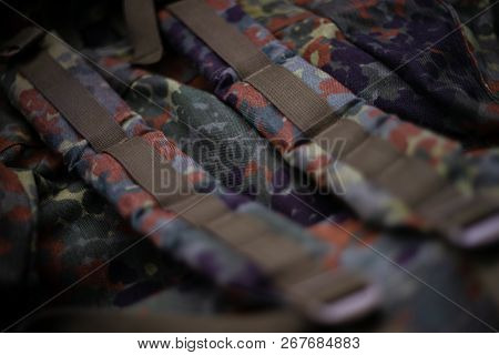 Military Camouflage Roomy Backpack. In The Frame Of The Strap And The Back Of A Backpack. Close-up V