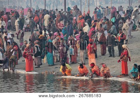 ALLAHABAD, INDIA - FEBRUARY 12, 2013: Thousands of Hindu devotees come to confluence of the Ganges and Yamuna River for holy dip during the festival Kumbh Mela. The world's largest religious gathering