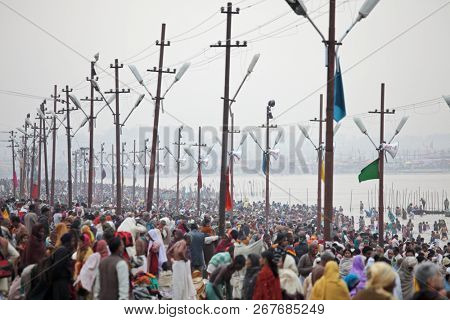 ALLAHABAD, INDIA - FEBRUARY 12, 2013: Thousands of Hindu devotees come to confluence of the Ganges and Yamuna River for holy dip during the festival Kumbh Mela. The world's largest religious gathering