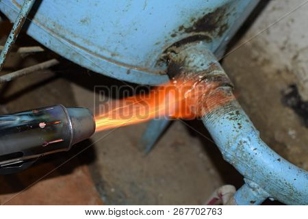Heating A Steel Pipe With A Blowtorch. The Flame Of A Blowtorch.