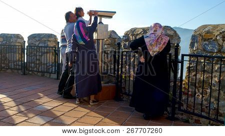 Konakli, Alanya - 06 July 2018: Arab Family Of Tourists On Viewing Platform With Binocular Near Fort