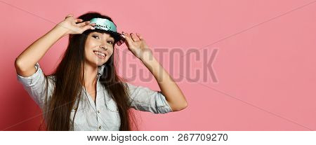 Studio Shot Of Pleased Beautiful Young Woman Posing In Eyemask. Happy Girl In Mask Sleeping Looking 