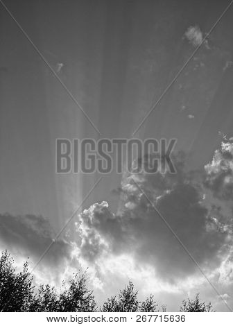 Bright Rays Of The Sun From Behind The Clouds, Black And White Photo