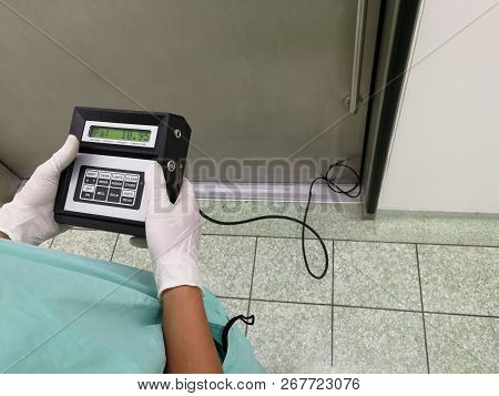 Inspector Using Differential Pressure Meter - Room Pressurization Monitoring.