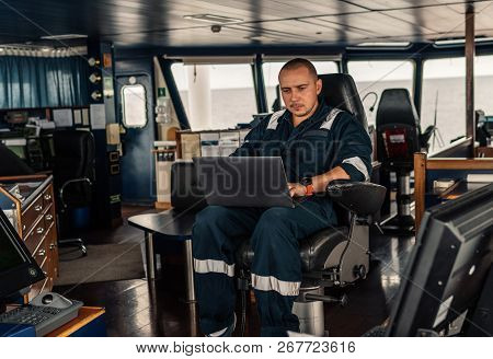 Marine Navigational Officer Is Using Laptop Or Notebook At Sea