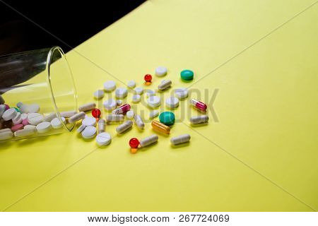 Vitamins Supplements In Bottle On Yellow Table.pills Medicine And Capsule Pills Medicine, Antibiotic