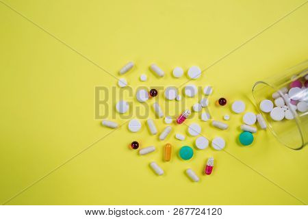 Vitamins Supplements In Bottle On Yellow Table.pills Medicine And Capsule Pills Medicine, Antibiotic