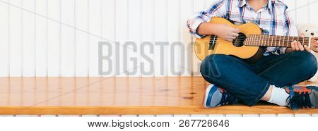 Boy Kid Playing Guitar At Home.