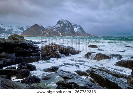 Rocky coast of fjord of Norwegian sea in winter. Skagsanden beach, Lofoten islands, Norway