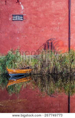 Walls Of Malmo Castle And A Small Boat Reflecting In A Moat, Sweden
