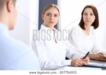 Group Of Business People Or Lawyers Discussing  Terms Of Transaction In Office. Colleagues Working A