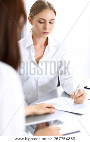 Group Of Business People Or Lawyers Discussing  Terms Of Transaction In Office. Colleagues Working A