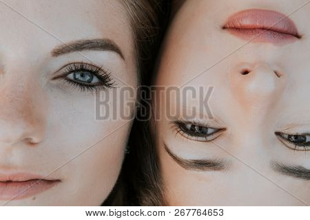 Two girlfriends lying next to each other