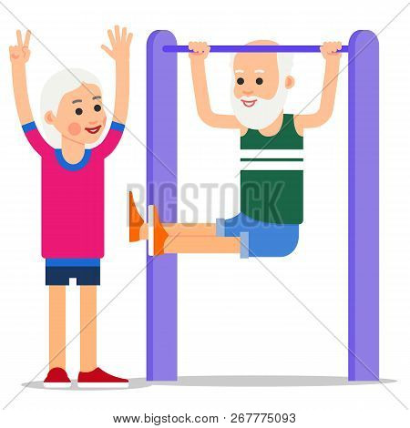 Elderly Man Making Pull Ups. One Senior Doing Pull-ups, Woman Stands Beside And Controls Exercises.