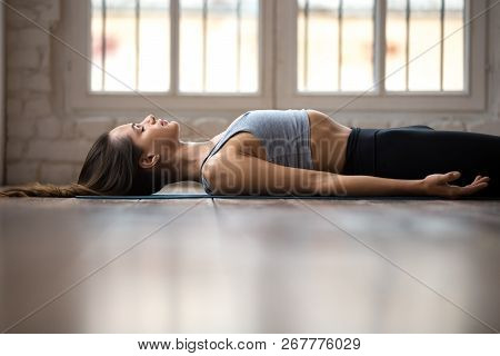 Young Sporty Attractive Woman Practicing Yoga, Doing Dead Body