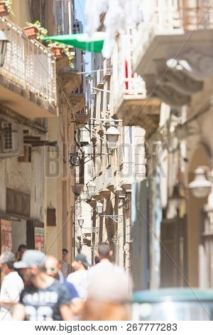Taranto, Apulia, Italy - May 31, 2017 - Tourists Walking Through The Small Alleyways Of Taranto