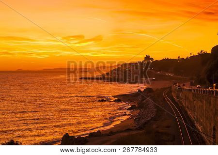 Spectacular Sunset Over The Costa Del Maresme With The Village Of Sant Pol De Mar In The Foreground 