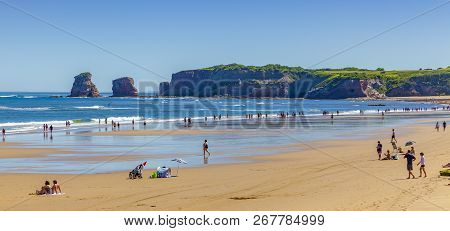 Hendaye, France - June 8: Tourists And Surfers Enjoy The Beach Of The Charming Seaside Resort Of Hen