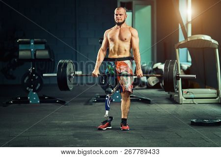 Sportsman With Prosthesis Working Out In Gym