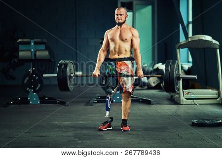 Sportsman With Prosthesis Working Out In Gym