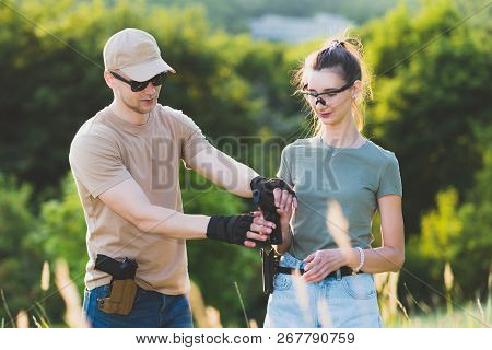 The Instructor Teaches The Girl To Shoot A Pistol At The Range