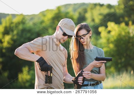 The Instructor Teaches The Girl To Shoot A Pistol At The Range