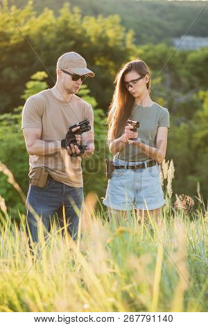 The Instructor Teaches The Girl To Shoot A Pistol At The Range