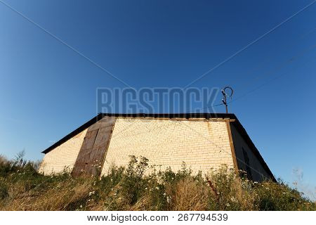 Brick Barn Under The Clear Blue Sky