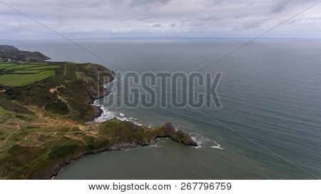 Aerial View Of Pobbles Bay And The Dramatic Three Cliffs Bay On The Gower Peninsula, Swansea, South 