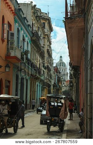 04/04/2016: Havana, Cuba: A Busy Street In The Socialist Country Capital With Rikshas And The Capito