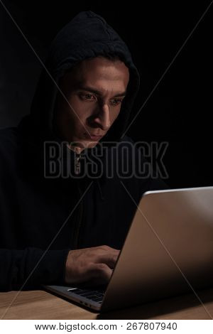 Hacker In Black Hoodie Using Laptop, Cuber Security Concept