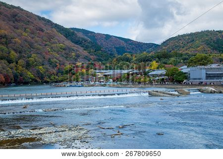 Togetsukyo Bridge In Arashiyama, Kyoto Prefecture, Japan During Koyo Vibrant Autumn Foliage Festival
