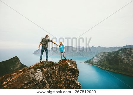 Travel Couple Hands Holding Together On Cliff Edge In Norway Man And Woman Family Healthy Lifestyle 
