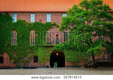 Courtyard In Stockholm City Hall Building (stadshuset) With Ivy Covered Brick Walls And Tiled Roof T
