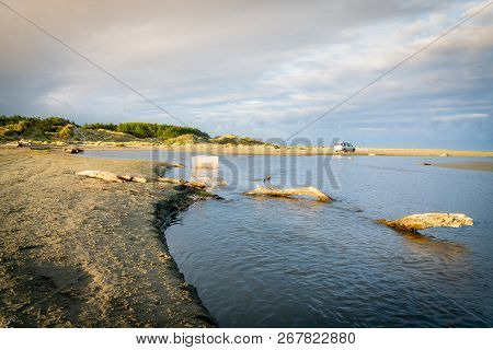 Levin New Zealand - September 29 2018;  Distant Fishermen, Nets In Stream By Old Log And Vehicle Whi