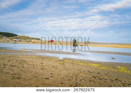 Levin New Zealand - September 29 2018;  Distant Fishermen And Vehicles White Baiting On Hokio Stream