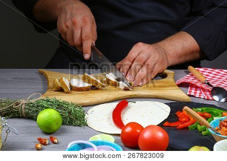 Hands Of A Professional Chef Cooking Tacos, Buritto Chopping Chicken Fillet. Mexican Food.