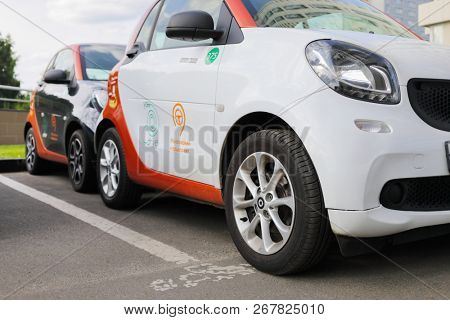 MOSCOW - JUN 22, 2018: White and black Mercedes Smart cars of Moscow carsharing company You drive are on parking, carsharing is system of short-term car rental