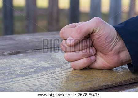 Man Banging His Fist On A Wooden Table