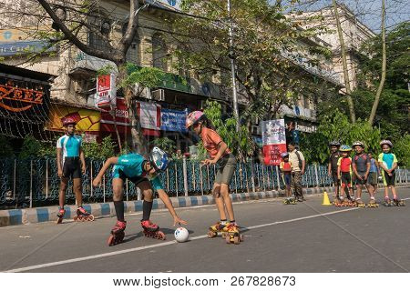 Kolkata, West Bengal, India - March 15th 2015 : Children Rollerskating With White Ball On Park Stree