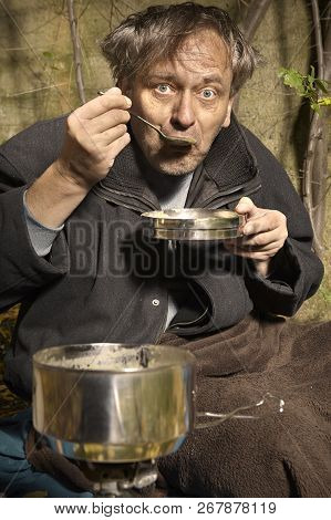 Ugly Pauper Man Living Outdoor Eating Lentil Soup On Street