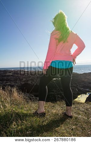 Beautiful Blond Woman Enjoying The Spectacular Sunset During The Golden Hour Along The Oregon Coastl