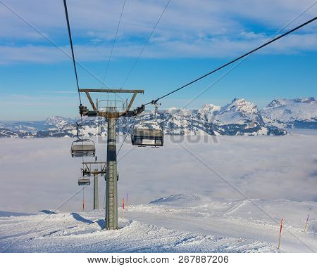 An Overhead Cable Car, Summits Of The Alps Rising From Sea Of Fog - A Wintertime View From The Frona