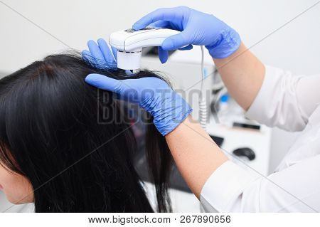 Trichoscopy Of The Scalp In A Medical Cosmetology Center. Scalp Hair Treatment