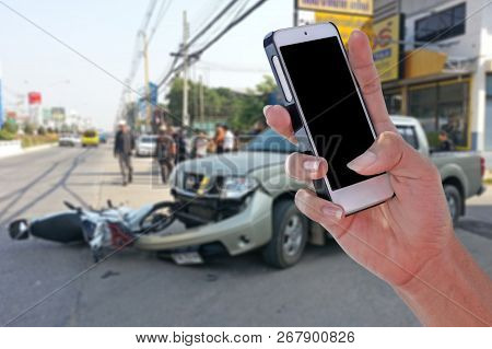 Man Using Smartphone At Roadside After Car Accident And Blurry Background  With Clipping Path On Scr