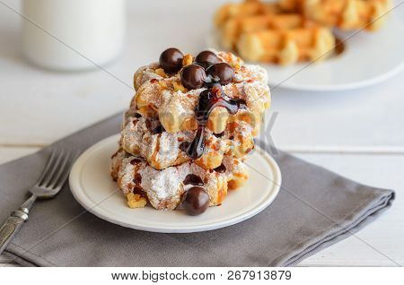 Delicious Belgian Waffles With Milk Chocolate Bolls,caramel Sauce  And Icing Sugar. Homemade Holiday