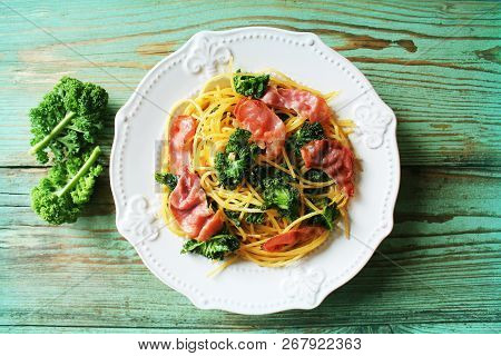 Delicious Spicy Linguine Pasta With Fried Cabbage Kale, Bacon, Garlic And Parmesan On A White Plate 