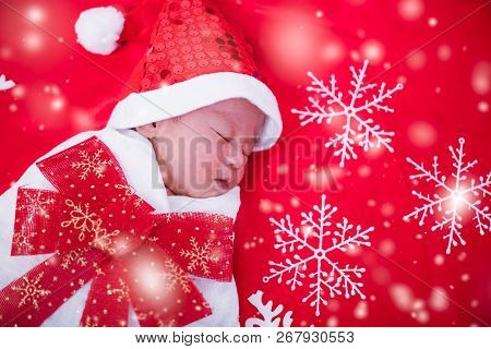 Newborn Baby Sleeping On Santa Het And Red Background,