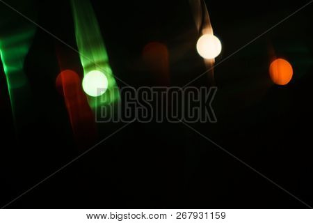 Lens Flare Optical Effect On Dark Background. Abstract Blurred Shiny Spotlights, Nightlight Or Festi